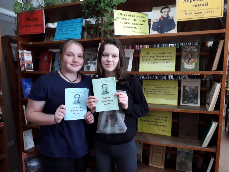 фото девушки стоят у выставки Лермонтова и держат брошюрки с рекомендованной литературой